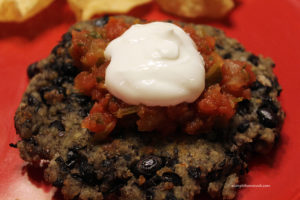 black bean patty topped with salsa and sour cream