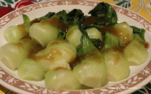 baby bok choy on platter with sauce