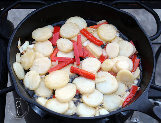 potatoes and peppers in cast iron skillet
