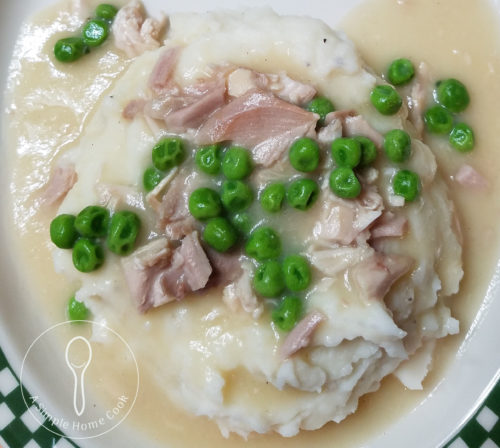creamed turkey over mashed potatoes on plate