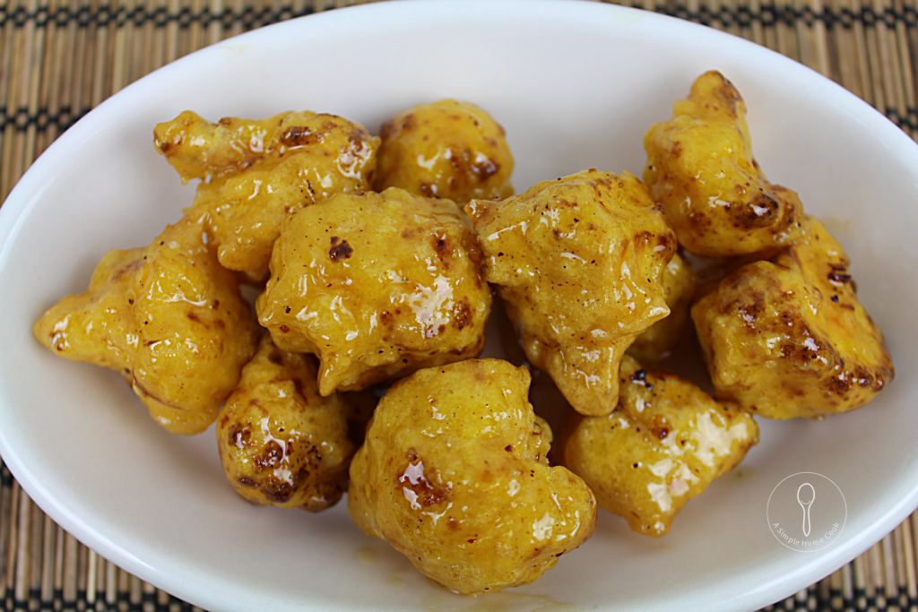 Deep Fried Cauliflower coated in a honey and orange sauce